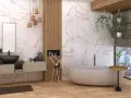 Nowoczesna łazienka z wanną i umywalką. Marmurowe płytki na ścianach sięgają do samej góry, tworząc elegancką przestrzeń.